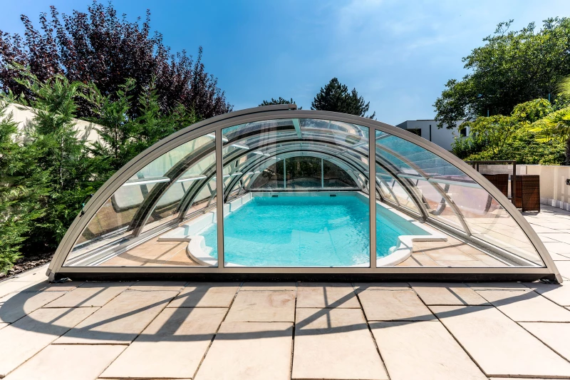 Arched Aquacomet pool enclosure over cocktail pool
